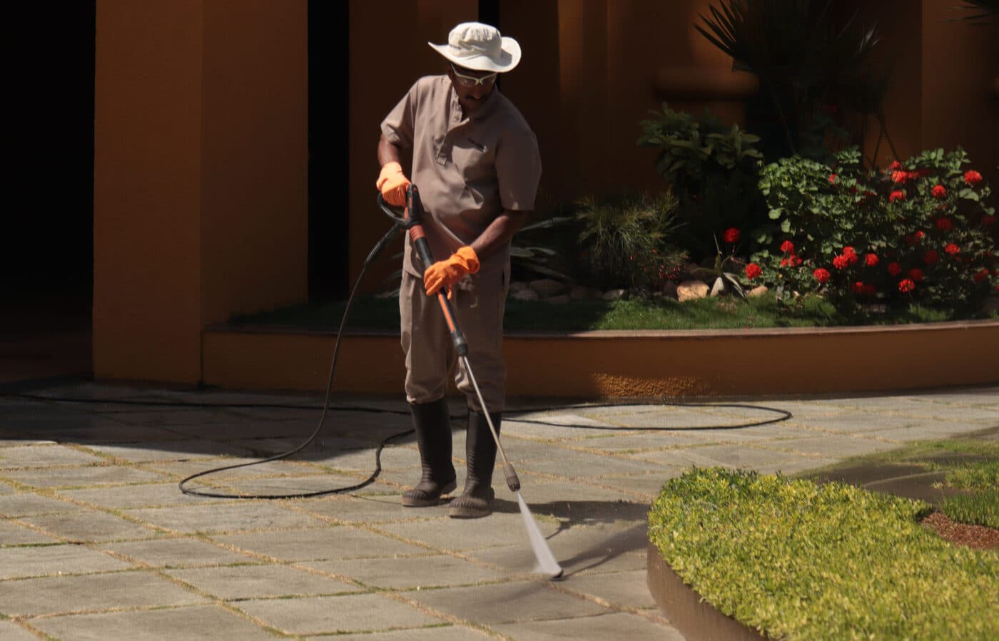 Technician pressure washing a residential walkway in Los Angeles